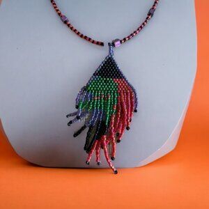 Hand beaded witch pendant.